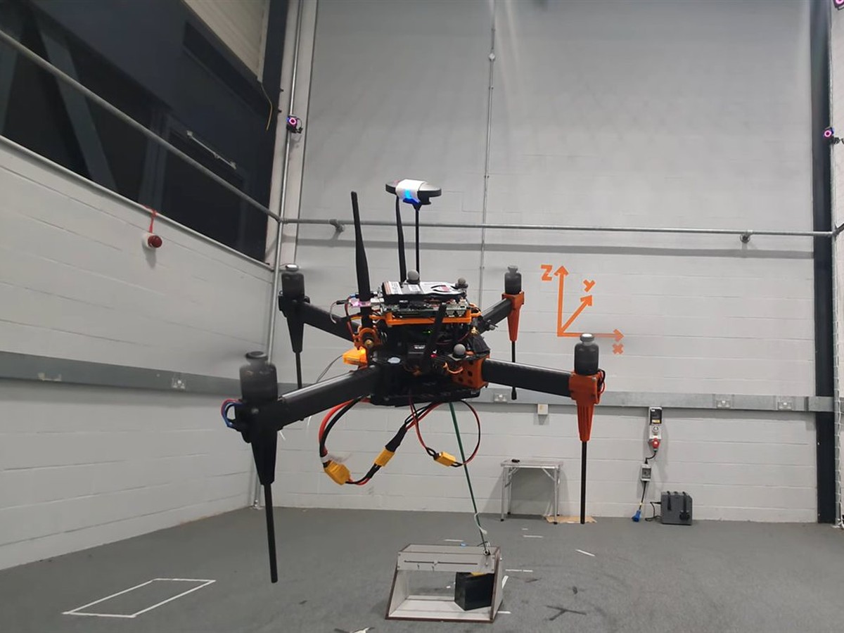 UAV carrying a payload during an indoor flight trial